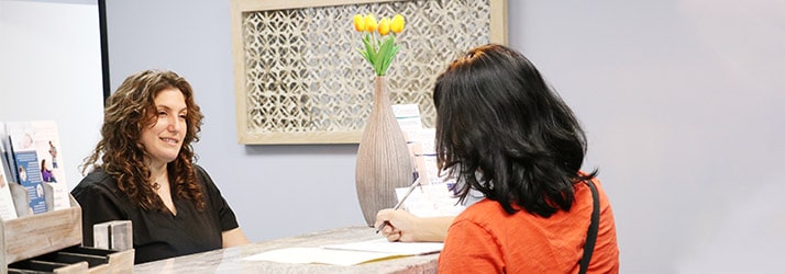 Chiropractor Los Angeles CA Heather Valinsky at Reception Desk